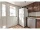Bright kitchen features white appliances and wooden cabinets at 6611 W Kingston Ln, Glendale, AZ 85306