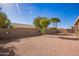 Backyard featuring gravel, mature trees, block wall, and covered patio of property at 6984 S Newport Ct, Chandler, AZ 85249