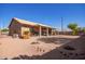 Spacious desert landscaped backyard with a covered patio, palm tree, and plenty of room to enjoy at 6984 S Newport Ct, Chandler, AZ 85249