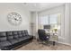 Home office featuring a futon, a desk and a clock on the wall at 6984 S Newport Ct, Chandler, AZ 85249