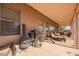 Inviting covered patio area features a grill, chiminea, lounge chairs, and views of the expansive backyard at 6984 S Newport Ct, Chandler, AZ 85249