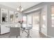 Bright dining room with a glass table, white chairs, and modern lighting at 6984 S Newport Ct, Chandler, AZ 85249