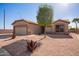 Tan single-story home featuring low maintenance desert landscaping and a two car garage at 6984 S Newport Ct, Chandler, AZ 85249
