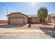 Tan single-story home featuring low maintenance desert landscaping and a two car garage at 6984 S Newport Ct, Chandler, AZ 85249