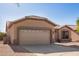 Tan single-story home featuring low maintenance desert landscaping and a two car garage at 6984 S Newport Ct, Chandler, AZ 85249