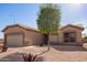 Tan single-story home featuring low maintenance desert landscaping and a two car garage at 6984 S Newport Ct, Chandler, AZ 85249