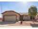 Tan single-story home featuring low maintenance desert landscaping and a two car garage at 6984 S Newport Ct, Chandler, AZ 85249