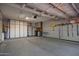 Spacious garage with epoxy flooring, white storage cabinets, work bench, and organized tools along the wall at 6984 S Newport Ct, Chandler, AZ 85249