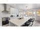Well-lit kitchen boasting stainless steel appliances, white cabinets, subway tile backsplash and kitchen island seating at 6984 S Newport Ct, Chandler, AZ 85249