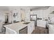 Bright kitchen with stainless steel appliances, white cabinets, kitchen island and stainless steel dishwasher at 6984 S Newport Ct, Chandler, AZ 85249
