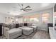 Bright living room with a large sectional sofa, modern fan, and stylish decor at 6984 S Newport Ct, Chandler, AZ 85249