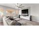 Bright living room with a large sectional sofa, modern fan, and stylish decor at 6984 S Newport Ct, Chandler, AZ 85249