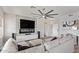 Bright living room with a large sectional sofa, modern fan, and stylish decor at 6984 S Newport Ct, Chandler, AZ 85249