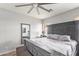 Neutral bedroom with king bed, ceiling fan, carpet, and large mirror at 6984 S Newport Ct, Chandler, AZ 85249