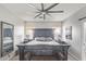 Spacious bedroom with a rustic wood bed frame, large windows, and calming decor at 6984 S Newport Ct, Chandler, AZ 85249
