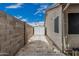 Spacious backyard featuring a convenient white storage shed and a stone-paved walkway at 705 W Country Estates Ave, Gilbert, AZ 85233