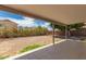 A covered patio looking out to a backyard with flowering bushes at 705 W Country Estates Ave, Gilbert, AZ 85233