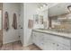 Bathroom vanity featuring granite countertops, dual sinks, white cabinets, and tile floors at 705 W Country Estates Ave, Gilbert, AZ 85233