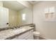 Bathroom vanity with granite counters, a mirror and window with shutters at 705 W Country Estates Ave, Gilbert, AZ 85233