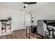 Bedroom featuring a ceiling fan, wood floors, and sliding door closet at 705 W Country Estates Ave, Gilbert, AZ 85233