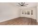Bright bedroom with wood floors and a bay window with plantation shutters for ample natural light at 705 W Country Estates Ave, Gilbert, AZ 85233