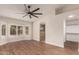 Bedroom boasts wood floors, a bay window, and an arched entry to an en-suite bathroom and closet at 705 W Country Estates Ave, Gilbert, AZ 85233