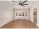 Spacious bedroom with wood floors, a bay window, and an arched entry to an attached bathroom at 705 W Country Estates Ave, Gilbert, AZ 85233