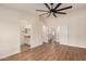 Bedroom with wood floors shows access to a bathroom with granite countertops and a walk-in closet at 705 W Country Estates Ave, Gilbert, AZ 85233
