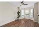 Bedroom featuring a ceiling fan, bay windows, and wood floors at 705 W Country Estates Ave, Gilbert, AZ 85233