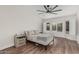 Comfortable bedroom featuring wood floors, a ceiling fan, and lots of natural light at 705 W Country Estates Ave, Gilbert, AZ 85233