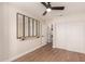 Bedroom with hardwood floors, ceiling fan, sliding closet doors and a glass wall decor at 705 W Country Estates Ave, Gilbert, AZ 85233
