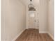 Clean foyer with wood floors, a decorative chandelier and a glass paneled front door at 705 W Country Estates Ave, Gilbert, AZ 85233