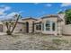 Lovely single-story home featuring a large picture window and arched entryway at 705 W Country Estates Ave, Gilbert, AZ 85233