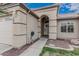 Close-up of the front entrance featuring an arched doorway and desert landscaping at 705 W Country Estates Ave, Gilbert, AZ 85233