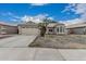 Charming single-story home with a spacious driveway and two-car garage at 705 W Country Estates Ave, Gilbert, AZ 85233