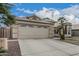 Welcoming front exterior with desert landscaping and a two-car garage at 705 W Country Estates Ave, Gilbert, AZ 85233