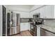 Modern kitchen area with stainless steel appliances and stylish backsplash at 705 W Country Estates Ave, Gilbert, AZ 85233