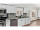 Kitchen area with stainless steel appliances, light cabinetry, and stone countertops at 705 W Country Estates Ave, Gilbert, AZ 85233