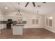 Open kitchen layout with white cabinets, updated appliances, and wood-style floors at 705 W Country Estates Ave, Gilbert, AZ 85233