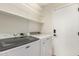 Laundry room with washer, dryer, and overhead shelves at 705 W Country Estates Ave, Gilbert, AZ 85233