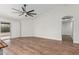 Bright living room with hardwood floors and a modern ceiling fan fixture at 705 W Country Estates Ave, Gilbert, AZ 85233