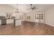 Open floor plan featuring wood floors, white cabinets and stainless steel appliances at 705 W Country Estates Ave, Gilbert, AZ 85233