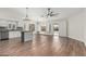 Open-concept living room with an island, hardwood floors, and natural lighting at 705 W Country Estates Ave, Gilbert, AZ 85233