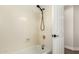 Shower and tub combo with white walls and black hardware at 705 W Country Estates Ave, Gilbert, AZ 85233