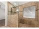 Shower features tile walls, a rain shower head, and a built-in bench, offering a luxurious bathing experience at 705 W Country Estates Ave, Gilbert, AZ 85233