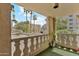 Balcony overlooks desert landscaping and surrounding building with palm trees at 7840 E Camelback Rd # 110, Scottsdale, AZ 85251