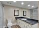 Bathroom with white vanity cabinets and a framed mirror offering a clean design at 7840 E Camelback Rd # 110, Scottsdale, AZ 85251