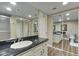 Updated bathroom with wood-look floors and granite countertop on a white vanity at 7840 E Camelback Rd # 110, Scottsdale, AZ 85251