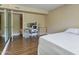Bedroom with wood-look floors and a built in desk for a functional workspace at 7840 E Camelback Rd # 110, Scottsdale, AZ 85251