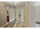 Hallway with a mirrored wall, white doors and access to the bathroom at 7840 E Camelback Rd # 110, Scottsdale, AZ 85251